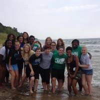 Group picture on the beach of all the women ant the women's leadership house